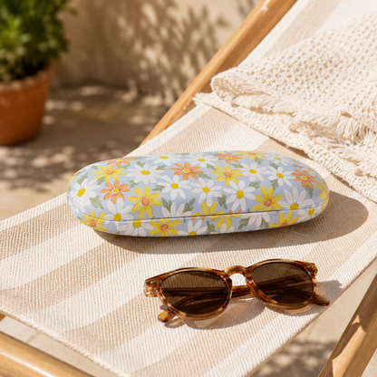 étui à lunettes rigide avec fleurs sur un transat en extérieur 